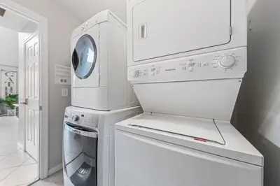 a laundry room with a washer and dryer at 6 Bedroom Villa - Emerald Island Retreat in Kissimmee