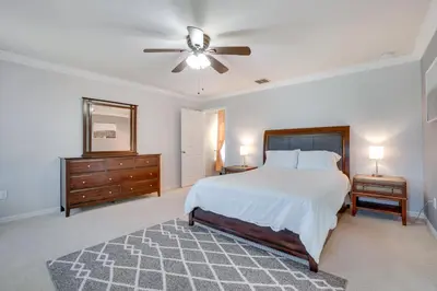 a bedroom with a bed and a ceiling fan at WFH, Relax and Enjoy At-Home Comforts in Orlando in Kissimmee