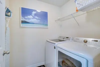a white washer and dryer in a laundry room at WFH, Relax and Enjoy At-Home Comforts in Orlando in Kissimmee