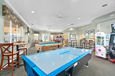 a game room with a pool table and arcade games at Wheelchair-Friendly Villa Near Disney World in Orlando