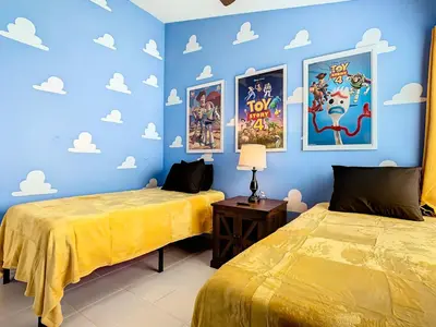 two beds in a room with blue walls at Dreamy 5BR, 3Bath Getaway, Pool, Spa, Near Disney in Orlando