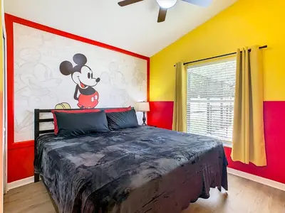 a bedroom with a mickey mouse mural on the wall at Dreamy 5BR, 3Bath Getaway, Pool, Spa, Near Disney in Orlando