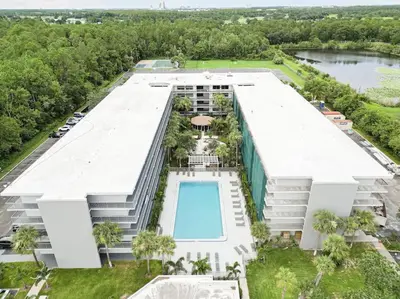 an aerial view of a building with a swimming pool at Orlando 1BR Relaxing Condo Next to Disney With Pool view in Kissimmee