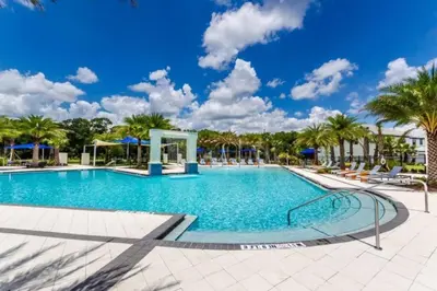 a swimming pool at a resort with palm trees at 3841 Kalistoga Stylish Villa 7BD Private Pool and Game Room in Kissimmee