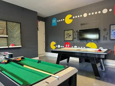 a billiard room with a pool table and a tv at 7738-IBRHAIM · 7738 Fairfax Dream Home in Orlando