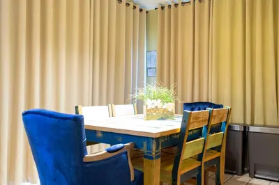 a table with blue chairs and a potted plant on it at Celebrate BR in Orlando