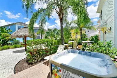 a jacuzzi tub in a yard with palm trees at Ocean Blue Cottage Near Disney With Private Hot Tub & Margaritaville Resort & Island H20 Waterpark Access - 3012Sr in Orlando