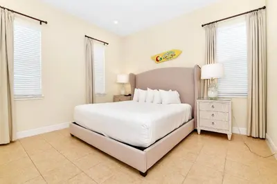 a white bedroom with a bed and two windows at Ocean Blue Cottage Near Disney With Private Hot Tub & Margaritaville Resort & Island H20 Waterpark Access - 3012Sr in Orlando