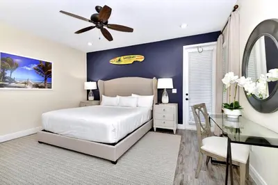 a bedroom with a king sized bed and a desk at Blue Moon Luxurious Cottage With Private Pool Near Disney With Margaritaville Resort & Island H2O Access - 8073Su in Orlando