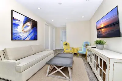 a living room with a couch and a table at Blue Moon Luxurious Cottage With Private Pool Near Disney With Margaritaville Resort & Island H2O Access - 8073Su in Orlando