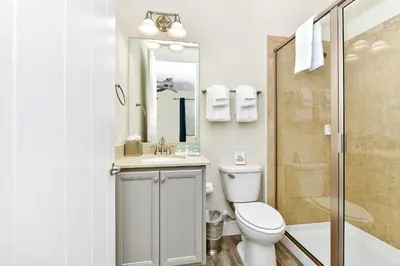 a bathroom with a toilet and a sink and a shower at Sunrise Cottage With Private Pool Near Disney With Margaritaville Resort & Island H2O Access - 8017Su in Orlando