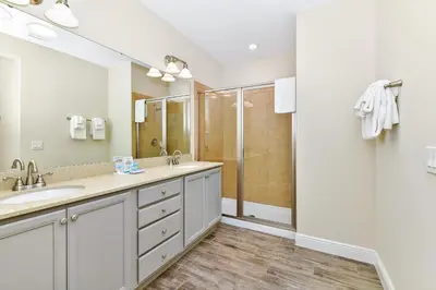 a bathroom with two sinks and a shower at Sunrise Cottage With Private Pool Near Disney With Margaritaville Resort & Island H2O Access - 8017Su in Orlando