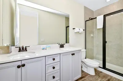 a white bathroom with a sink and a toilet at Pearly White Villa Near Disney With Margaritaville Resort & Island H2O Access - 3061Cs in Orlando