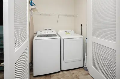 a white washer and dryer in a small room at Sea Shell Blue Cottage Near Disney With Private Pool And Margaritaville Resort & Island H2O Access - 8039Kd in Orlando