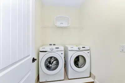 a laundry room with a washer and a dryer at Summer Breeze Villa Near Disney With Margaritaville Resort & Island H20 Waterpark Access - 2960Cs in Orlando