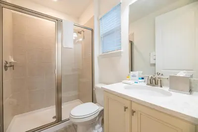 a bathroom with a toilet and a shower and a sink at Vibrant Cottage With Private Pool Near Disney With Margaritaville Resort & Island H2O Access - 8043Kd in Orlando