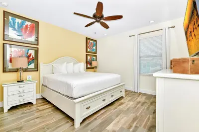 a bedroom with a bed and a ceiling fan at Beachy Daze Cottage Near Disney With Margaritaville Resort & Island H20 Waterpark Access - 2916Sr in Orlando