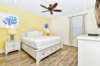 a bedroom with a bed and a ceiling fan at Beachy Daze Cottage Near Disney With Margaritaville Resort & Island H20 Waterpark Access - 2916Sr in Orlando