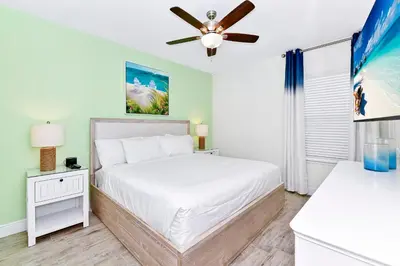 a bedroom with a bed and a ceiling fan at Dreamy Villa Near Disney With Margaritaville Resort & Island H2O Access - 3020Cs in Orlando