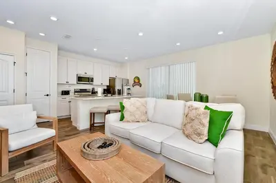 a living room with a white couch and a table at Tangerine Villa Near Disney With Margaritaville Resort And Island H20 Waterpark Access - 8178Cp in Orlando