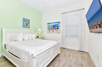 a white bedroom with a white bed and a window at Sunny Cottage Near Disney With Margaritaville Resort & Island H20 Waterpark Access - 3013Sp in Orlando