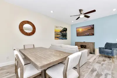 a dining room with a table and a ceiling fan at Making Memories Villa Near Disney With Margaritaville Resort & Island H20 Access - 8115Cp in Kissimmee