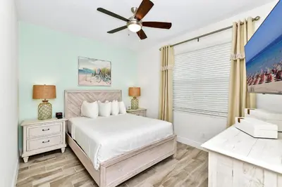 a bedroom with a bed and a ceiling fan at Breezy Blue Villa Near Disney With Margaritaville Resort Access - 3120Cs in Orlando