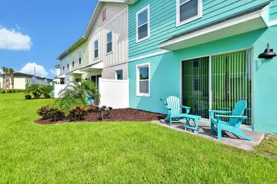 a blue house with two blue chairs on the front yard at Breezy Blue Villa Near Disney With Margaritaville Resort Access - 3120Cs in Orlando