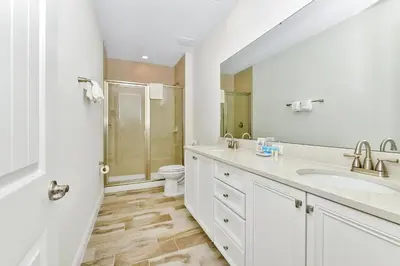 a white bathroom with a sink and a toilet at Breezy Blue Villa Near Disney With Margaritaville Resort Access - 3120Cs in Orlando