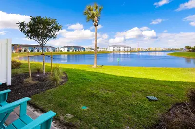 a park with a palm tree and a body of water at Lime Green Villa Near Disney With Margaritaville Resort & Island H20 Waterpark Access - 2944Or in Orlando