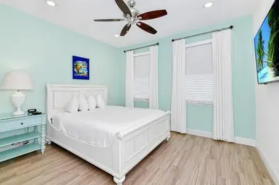 a bedroom with a white bed and a ceiling fan at Luxury Cottage Near Disney With Private Pool & Margaritaville Resort And Island H20 Waterpark Access - 3088Ph in Orlando
