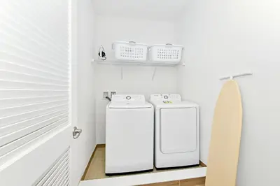 two white washers and a surfboard in a room at Luxury Cottage Near Disney With Private Pool & Margaritaville Resort And Island H20 Waterpark Access - 3088Ph in Orlando