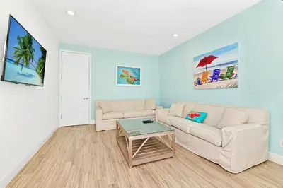 a living room with a couch and a table at Luxury Cottage Near Disney With Private Pool & Margaritaville Resort And Island H20 Waterpark Access - 3088Ph in Orlando