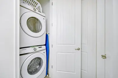 a washer and dryer in a room with a door at Beautiful Villa Near Disney With Margaritaville Resort & Island H20 Waterpark Access - 2976Cs in Orlando