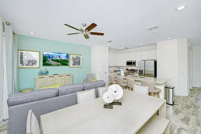 a living room with a couch and a table at Beautiful Villa Near Disney With Margaritaville Resort & Island H20 Waterpark Access - 2976Cs in Orlando