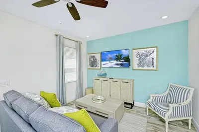 a living room with a couch and a table at Beautiful Villa Near Disney With Margaritaville Resort & Island H20 Waterpark Access - 2976Cs in Orlando