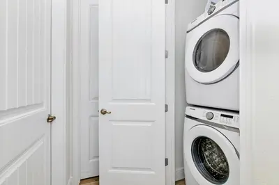 a washer and dryer in a white laundry room at Key Lime Villa Near Disney With Margaritaville Resort & Island H20 Waterpark Access - 3073Cs in Orlando