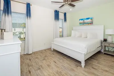 a white bedroom with a bed and a window at Beautiful Villa Near Disney With Margaritaville Resort & Island H20 Waterpark Access - 2933Cs in Orlando
