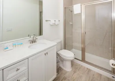 a white bathroom with a toilet and a shower at Beautiful Villa Near Disney With Margaritaville Resort & Island H20 Waterpark Access - 2933Cs in Orlando