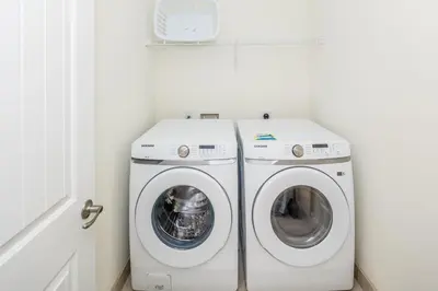a laundry room with a washer and dryer at Beautiful Villa Near Disney With Margaritaville Resort & Island H20 Waterpark Access - 2933Cs in Orlando