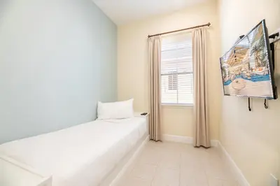 a bedroom with a bed and a window at Shore To Please Cottage Near Disney With Margaritaville Resort & Island H2O Access - 3044Sp in Orlando