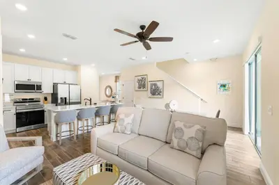 a living room with a couch and a kitchen at Orange Bliss Villa Near Disney With Margaritaville Resort & Island H20 Waterpark Access - 2955Cl in Kissimmee