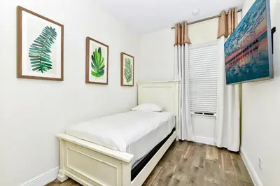 a white bedroom with a bed and a window at Perfect Family Villa Near Disney With Margaritaville Resort & Island H20 Waterpark Access - 3168Cs in Orlando