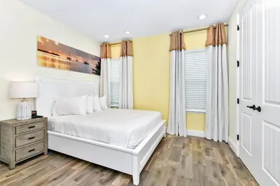 a bedroom with a white bed and yellow walls at Perfect Family Villa Near Disney With Margaritaville Resort & Island H20 Waterpark Access - 3168Cs in Orlando