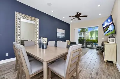 a dining room with a table and chairs and a mirror at Aqua Blue Cottage Near Disney With Margaritaville Resort & Island H20 Waterpark Access - 2930Sr in Orlando