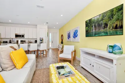 a living room with a couch and a kitchen at Colorful Villa Near Disney With Margaritaville Resort & Island H20 Waterpark Access - 3140Cs in Orlando