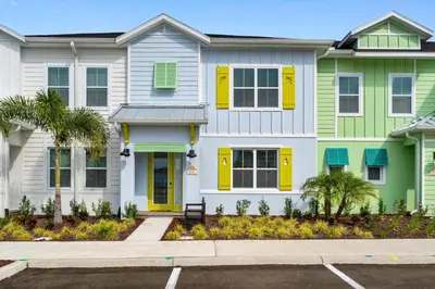 a row of houses with yellow and green shutters at Alluring Villa Near Disney With Margaritaville Resort & Island H2O Access - 3057Cs in Orlando