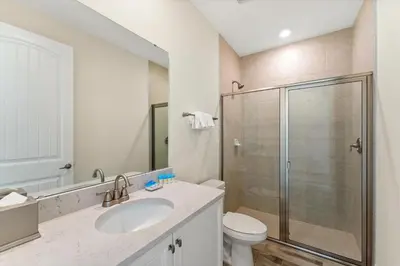 a bathroom with a shower and a toilet and a sink at Alluring Villa Near Disney With Margaritaville Resort & Island H2O Access - 3057Cs in Orlando