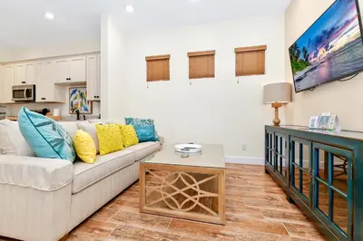 a living room with a couch and a table at Pina Cabana Cottage Near Disney With Margaritaville Resort & Island H2O Access - 3070Kl in Orlando