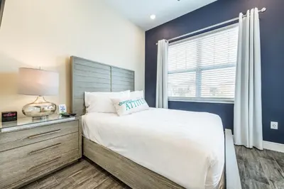 a bedroom with a large bed and a window at Sail Away! Beautiful Cottage With Private Hot Tub Near Disney With Margaritaville Resort & Island H2O Access - 3045Sp in Orlando